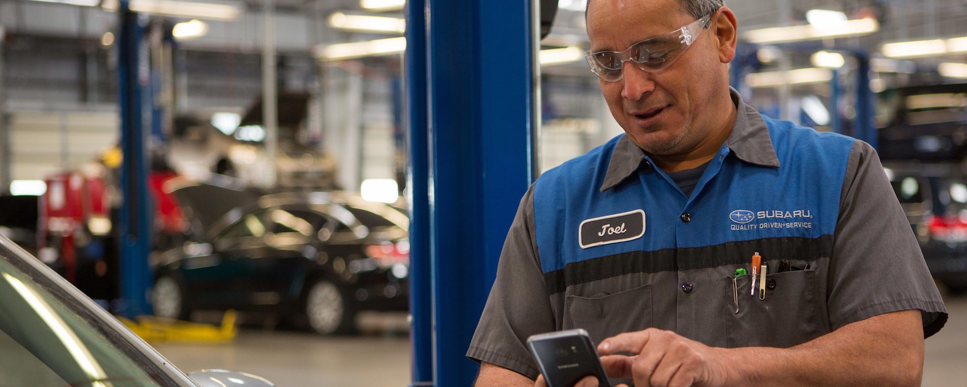 Continental Automotive Group mechanic using smartphones in retail
