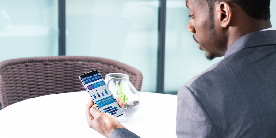 Photo of phone in use by business person