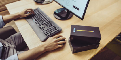 IT manager using mobile device mangement software at a desktop computer