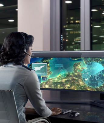 Government worker views a detailed map on a wide-screen monitor