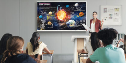 Teacher with interactive whiteboard speaking in front of classroom