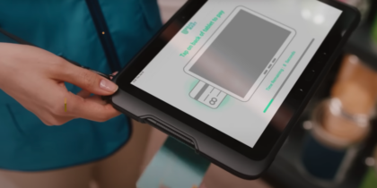Retail associate holding up Samsung tablet with mPOS
