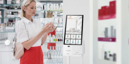 In a retail shoe store, a shopper uses an interactive wall display to browse the available products.